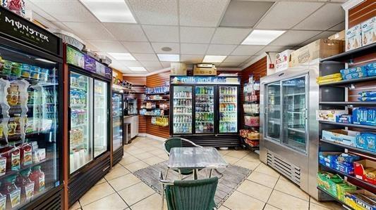 interior space featuring tile patterned flooring and a drop ceiling
