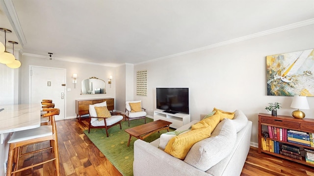 living area with crown molding and wood finished floors