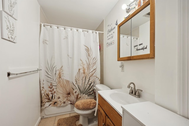 bathroom featuring tile patterned flooring, vanity, and toilet