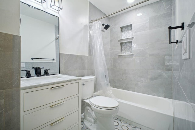 full bathroom with shower / bathtub combination with curtain, vanity, tile walls, and toilet