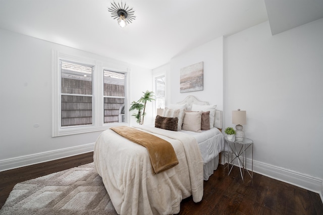 bedroom featuring baseboards and wood finished floors
