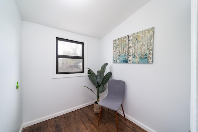 sitting room with baseboards, wood finished floors, and vaulted ceiling