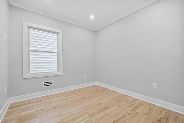 unfurnished room featuring plenty of natural light, light hardwood / wood-style floors, and ornamental molding