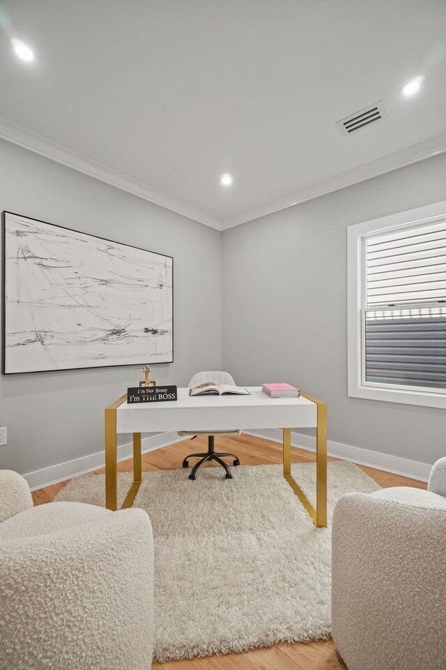 office area with hardwood / wood-style flooring and crown molding