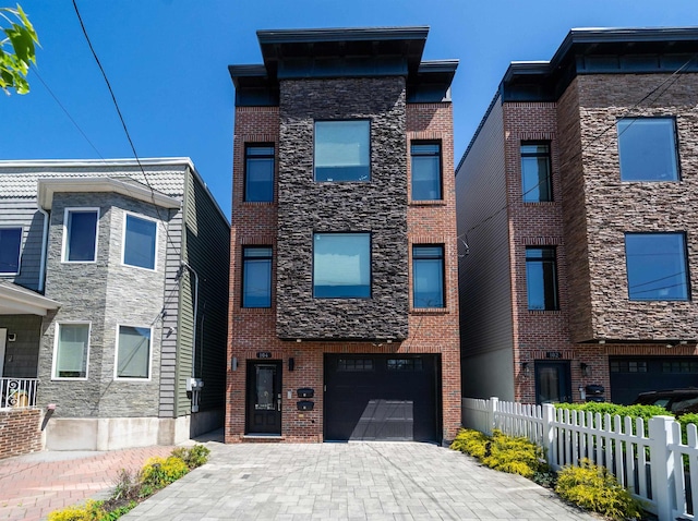104 Poplar St Unit 1, Jersey City, NJ 07307 - view of front of house with an attached garage, driveway, and brick siding