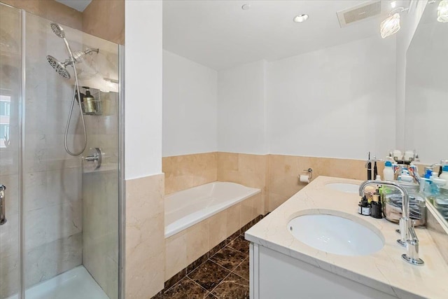 bathroom with tile patterned flooring, vanity, and independent shower and bath