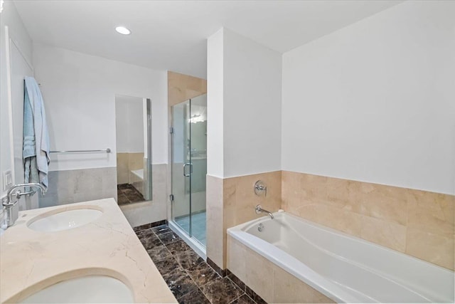 bathroom featuring vanity and shower with separate bathtub