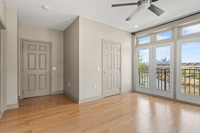 interior space with light wood-style floors, a ceiling fan, and recessed lighting