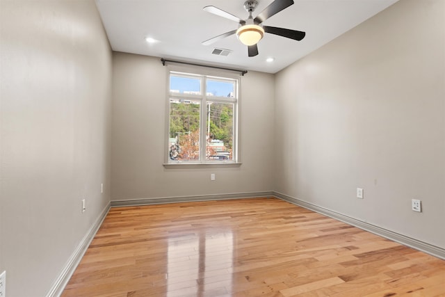 empty room with visible vents, recessed lighting, light wood-style flooring, a ceiling fan, and baseboards