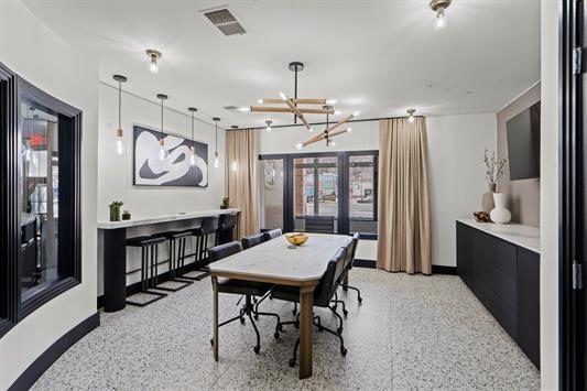 dining room featuring baseboards, an inviting chandelier, visible vents, and light speckled floor