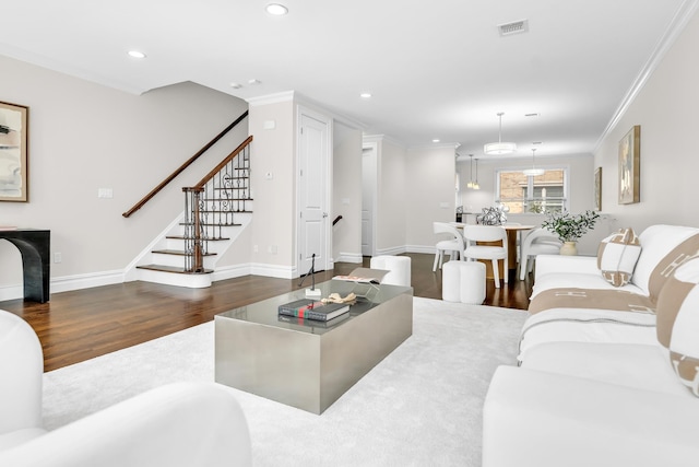 living room with crown molding and dark wood-type flooring