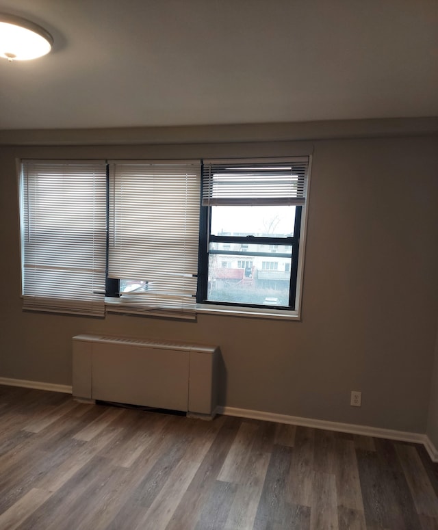 spare room with hardwood / wood-style floors and radiator