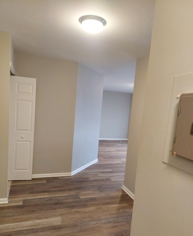 hallway featuring dark wood-type flooring and electric panel