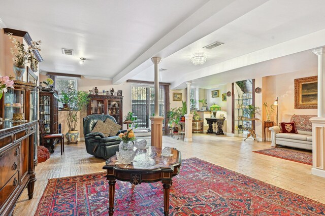 202 7th St Unit 1, Jersey City, NJ 07302 - living area with baseboards, decorative columns, wood-type flooring, and visible vents