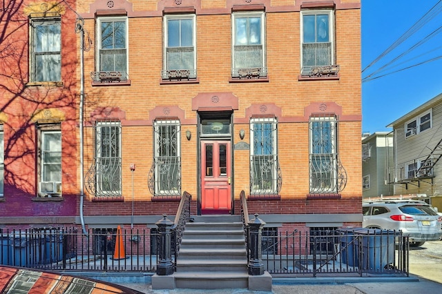 202 7th St Unit 1, Jersey City, NJ 07302 - view of property featuring brick siding and fence