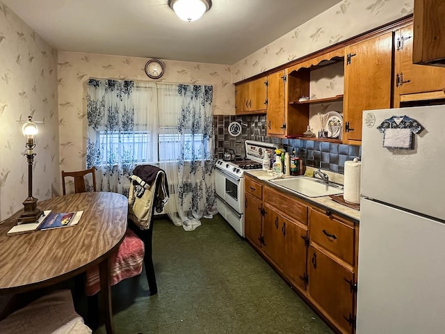 kitchen featuring white appliances and sink