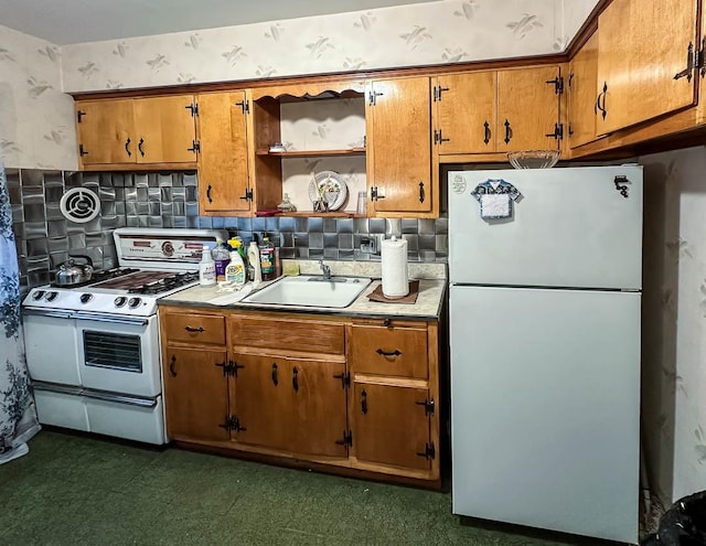 kitchen featuring tasteful backsplash, sink, and white appliances