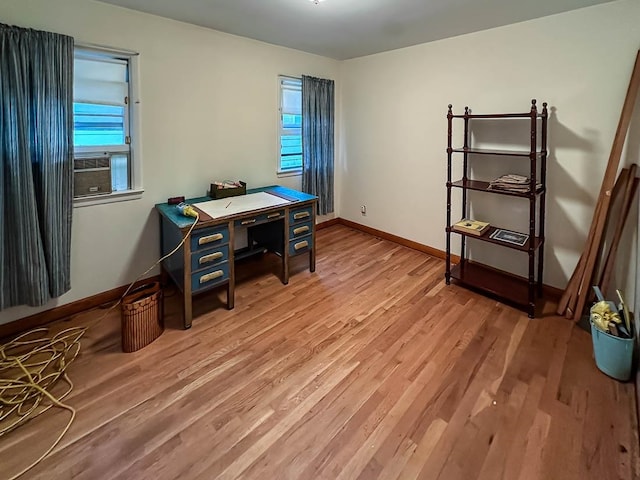 office with light hardwood / wood-style floors and cooling unit