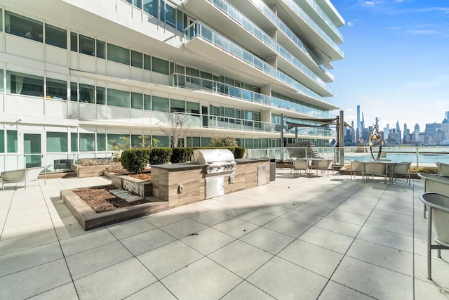 view of patio / terrace featuring area for grilling, grilling area, and a view of city