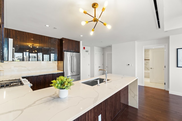 kitchen with dark wood-type flooring, a sink, modern cabinets, range, and high end refrigerator