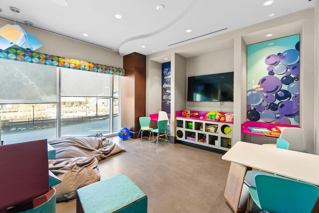 recreation room featuring concrete flooring and recessed lighting