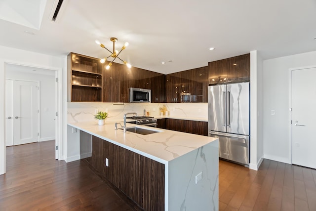 kitchen with appliances with stainless steel finishes, decorative backsplash, dark brown cabinets, and modern cabinets