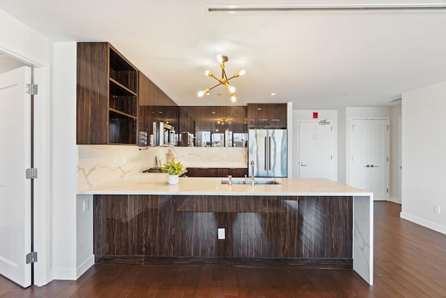 kitchen with open shelves, high end fridge, dark brown cabinetry, modern cabinets, and a peninsula