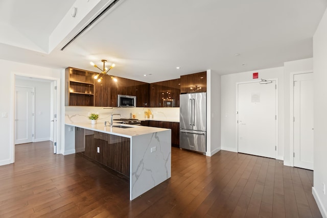 kitchen with dark wood finished floors, modern cabinets, a peninsula, stainless steel appliances, and open shelves