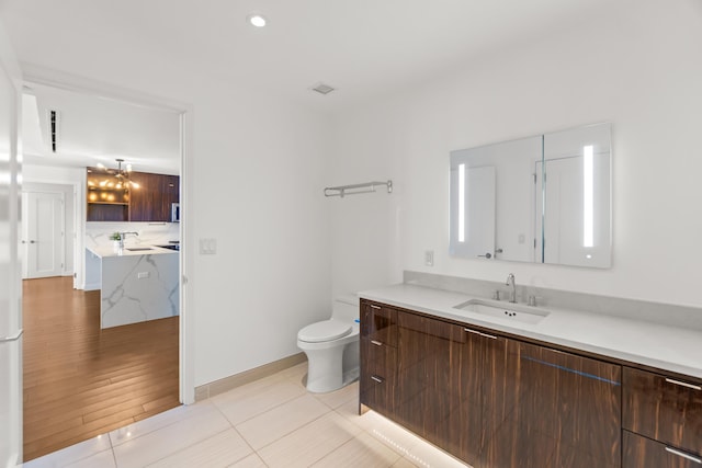 bathroom with toilet, tile patterned floors, recessed lighting, and vanity