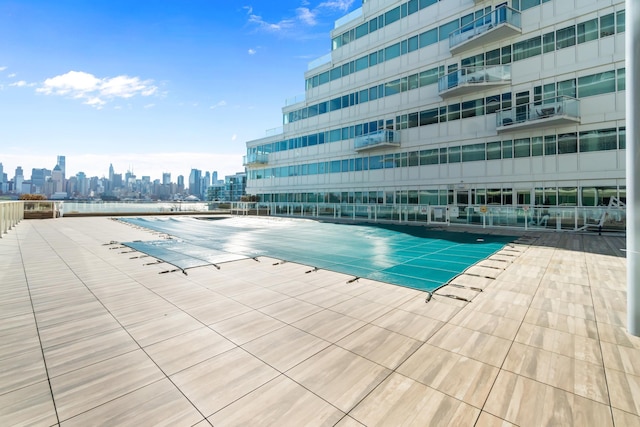 view of swimming pool with a view of city