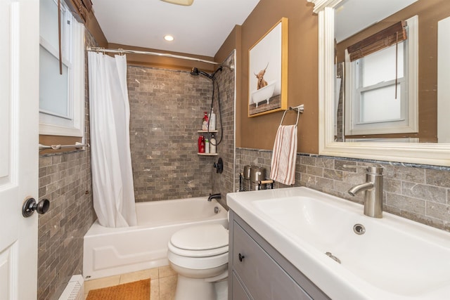 full bath with vanity, shower / bathtub combination with curtain, tile walls, toilet, and tile patterned floors