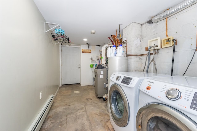 clothes washing area featuring a baseboard heating unit, laundry area, concrete block wall, and washer and clothes dryer