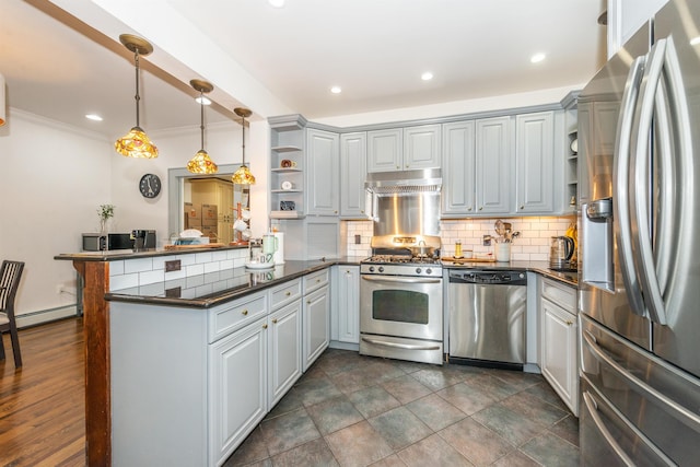 kitchen with under cabinet range hood, open shelves, dark countertops, stainless steel appliances, and a peninsula