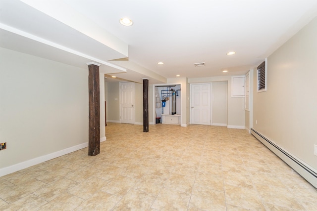 finished below grade area with baseboard heating, recessed lighting, visible vents, and baseboards