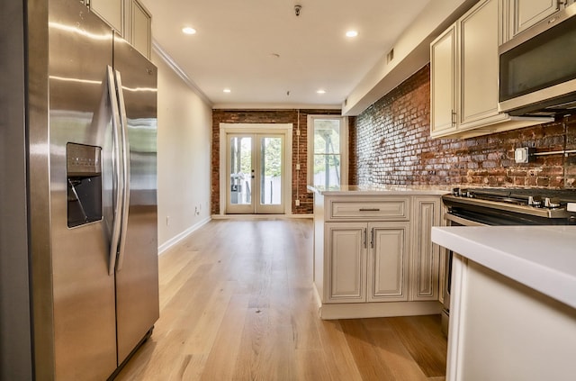 116 Ogden Ave Unit Ga, Jersey City, NJ 07307 - kitchen with stainless steel appliances, cream cabinetry, light wood-style flooring, light countertops, and ornamental molding
