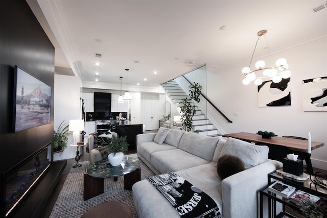 living room with an inviting chandelier and ornamental molding