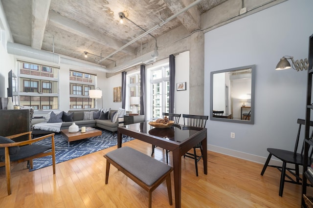 140 Bay St Unit 6E, Jersey City, NJ 07302 - dining space with light wood-style floors and a towering ceiling