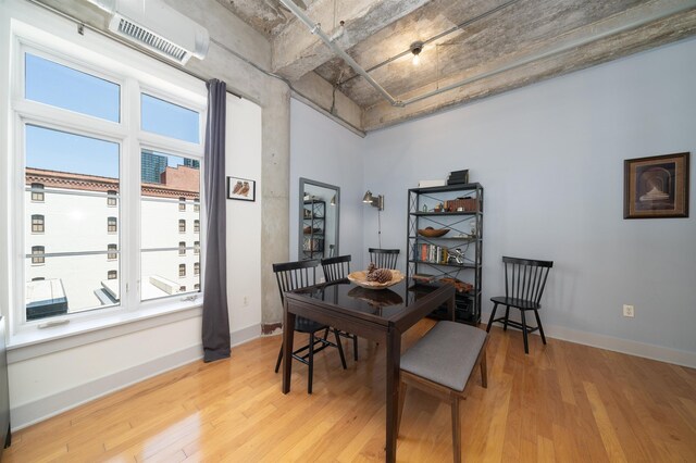 140 Bay St Unit 6E, Jersey City, NJ 07302 - dining space featuring light wood-style flooring, plenty of natural light, and an AC wall unit