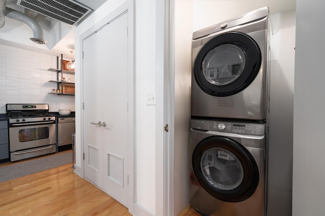 140 Bay St Unit 6E, Jersey City, NJ 07302 - laundry room with stacked washer / drying machine and light wood-style flooring