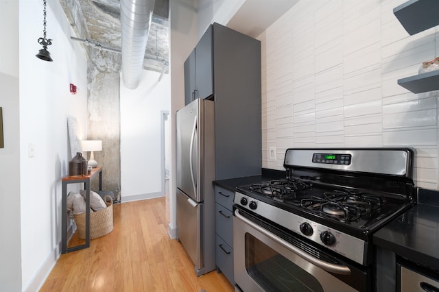 140 Bay St Unit 6E, Jersey City, NJ 07302 - kitchen featuring stainless steel appliances, dark countertops, light wood-type flooring, and tasteful backsplash