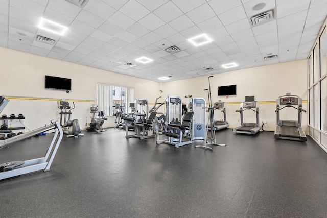 gym with a paneled ceiling