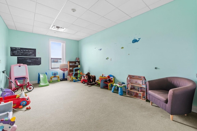 game room with a paneled ceiling and carpet flooring