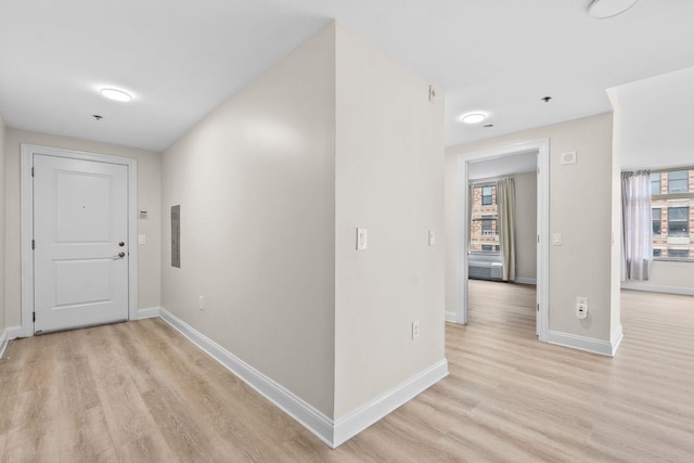 hall featuring electric panel and light wood-type flooring