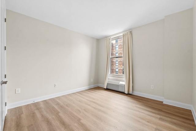 empty room with light hardwood / wood-style flooring