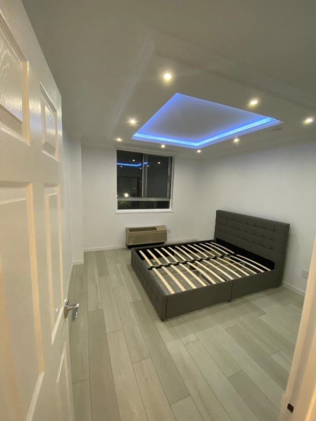 100 Manhattan Ave Unit 1301, Union City, NJ 07087 - bedroom with a wall mounted AC, wood finished floors, recessed lighting, and a tray ceiling