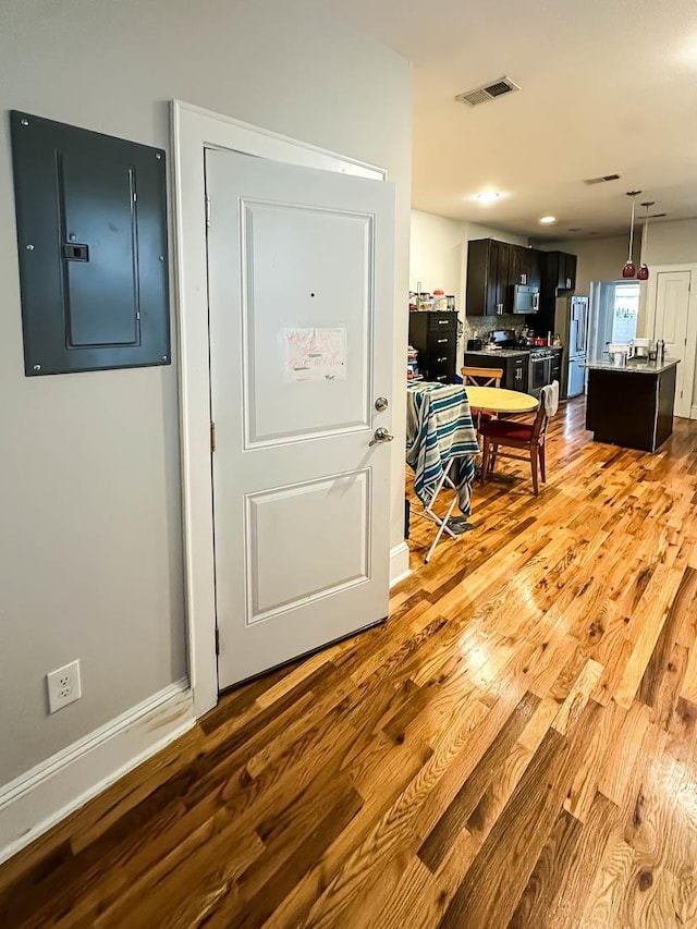 entryway featuring electric panel and light hardwood / wood-style floors