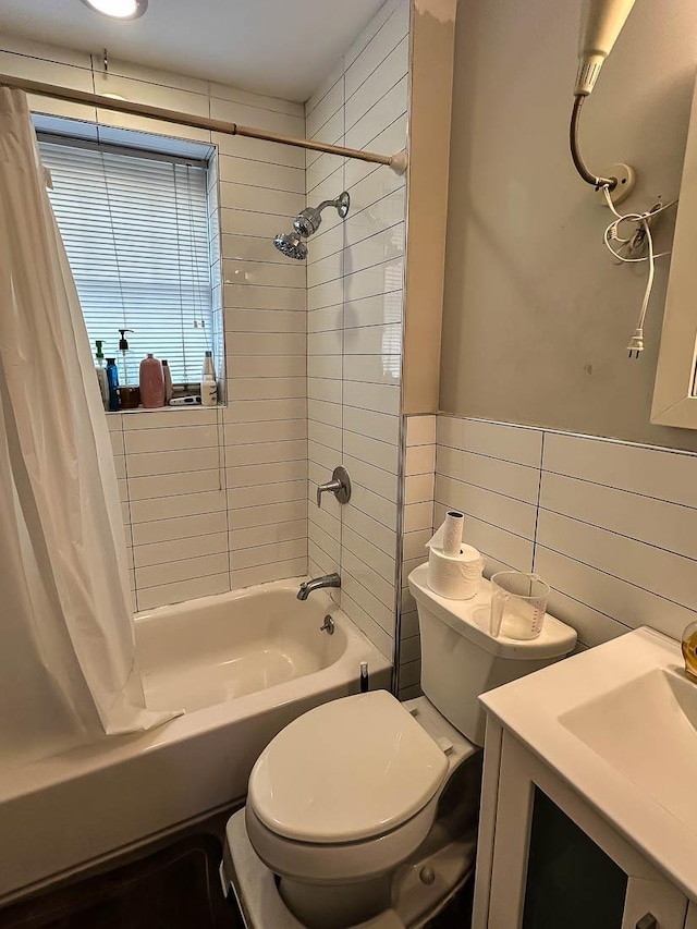 full bathroom with toilet, shower / bathtub combination with curtain, tile walls, and vanity