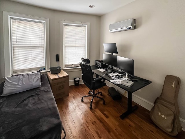 office with a wall mounted air conditioner and dark hardwood / wood-style floors