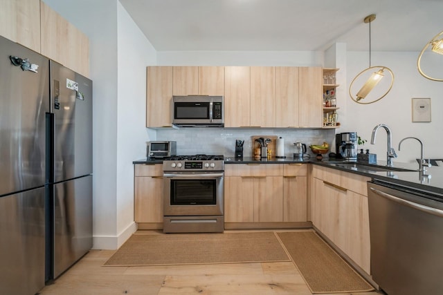 kitchen with modern cabinets, light brown cabinets, and stainless steel appliances