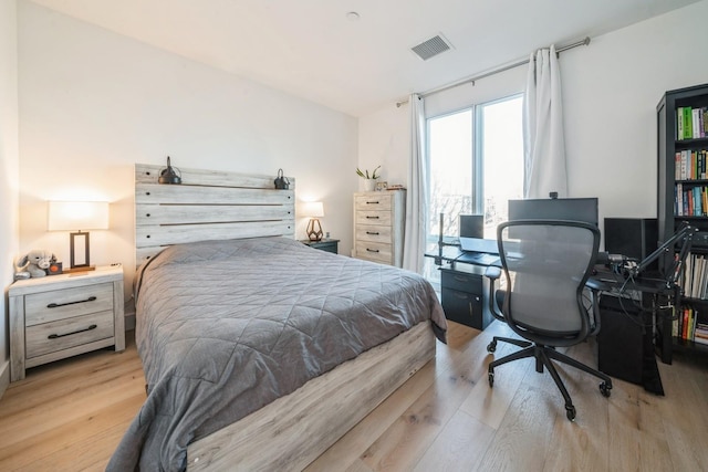 bedroom with visible vents and wood finished floors